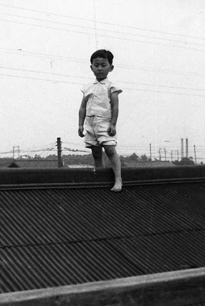 On the roof of my house, surveying my neighborhood, Akashicho, in 1957.