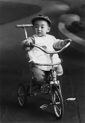 My 2nd or 3rd birthday. The tricycle was a birthday present.