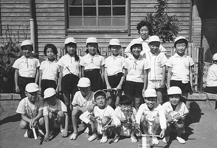 Far left front, Shigeru. I am  holding a baton for the relay race.