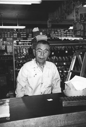 Grandfather in his shoe store with modern shoes