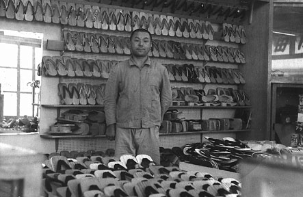 Tatsu Go-Ro Yamada (my grandfather) in his shoe store as a young man, surrounded by geta.