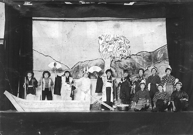 My mom, Mitsuko, appears in a third grade school play holding the hinomaru (red sun) fan