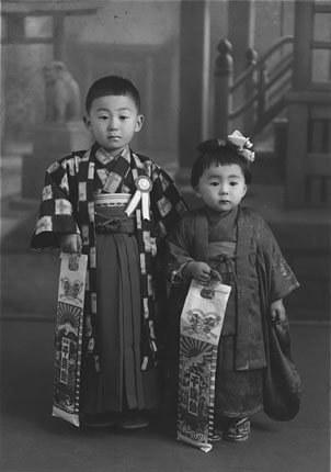 With my sister Haruyo, 3-5-7 celebration; wearing kimonos, holding long candy